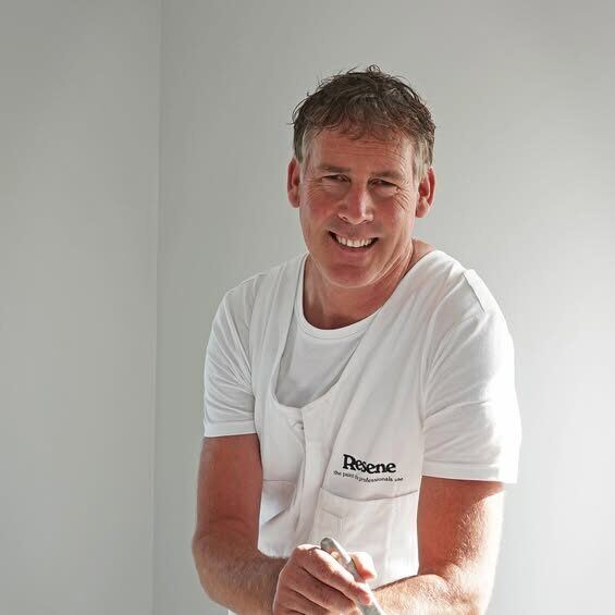 Jason Ward, painter and decorator, on the job in a Resene apron